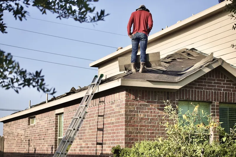 Professional roofer working on a residential roof in Bowers Corner
